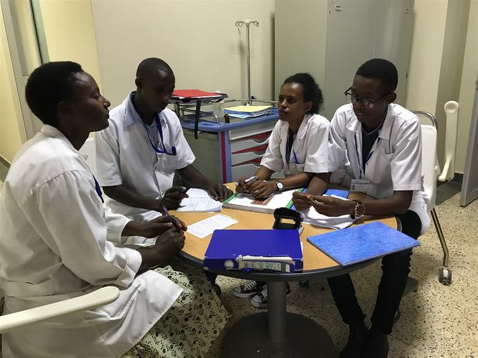 Clinical Instructor getting updates from students regarding their patient care for the day.