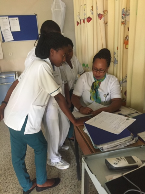 Ward nurse taking time to the teach nursing students as she takes care of her patients.